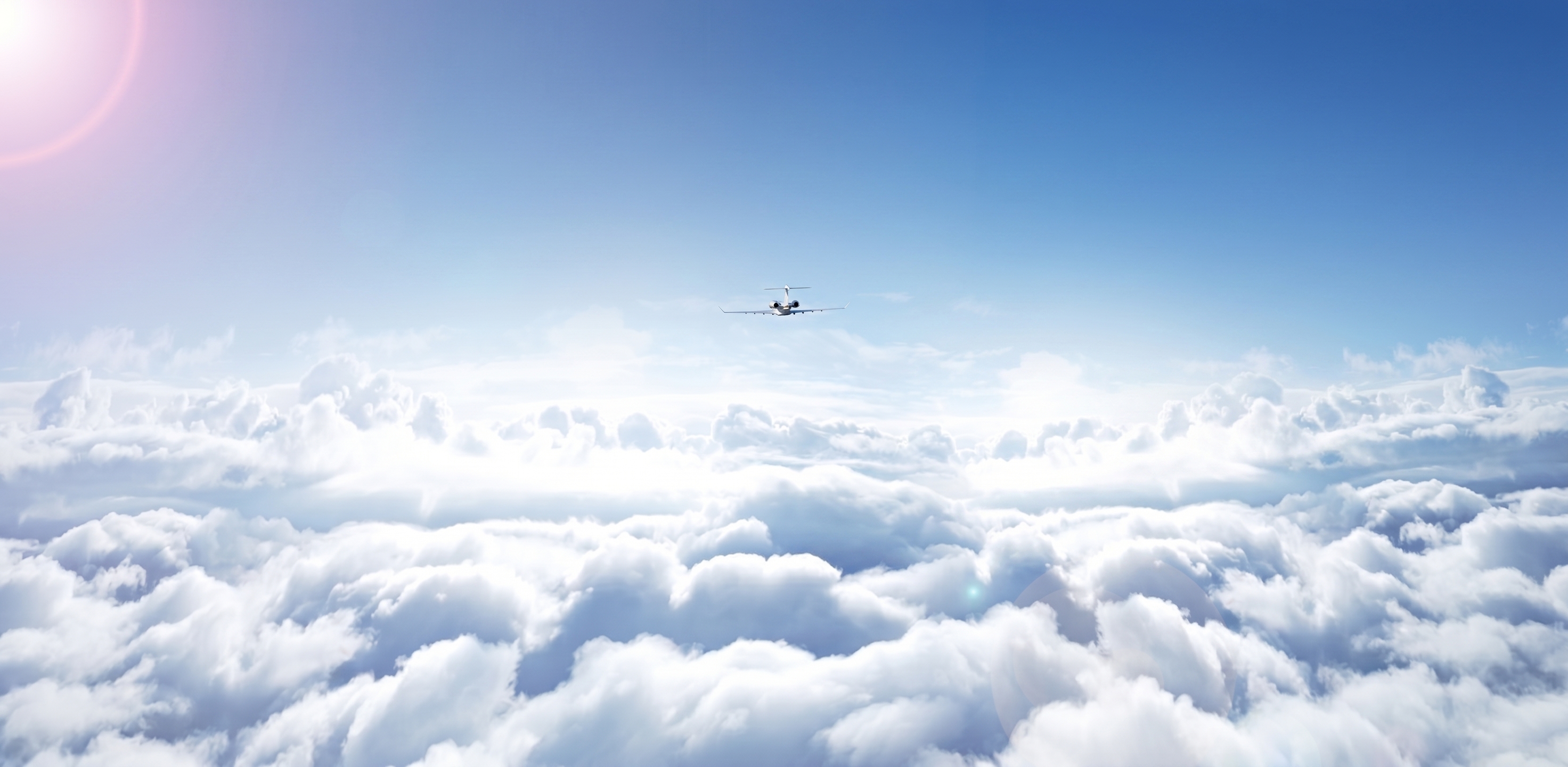Private jet flying above the clouds