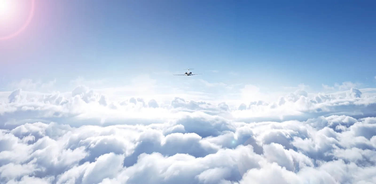 Private jet flying above a cloud deck