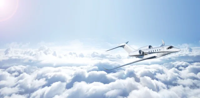 Private jet flying above the clouds